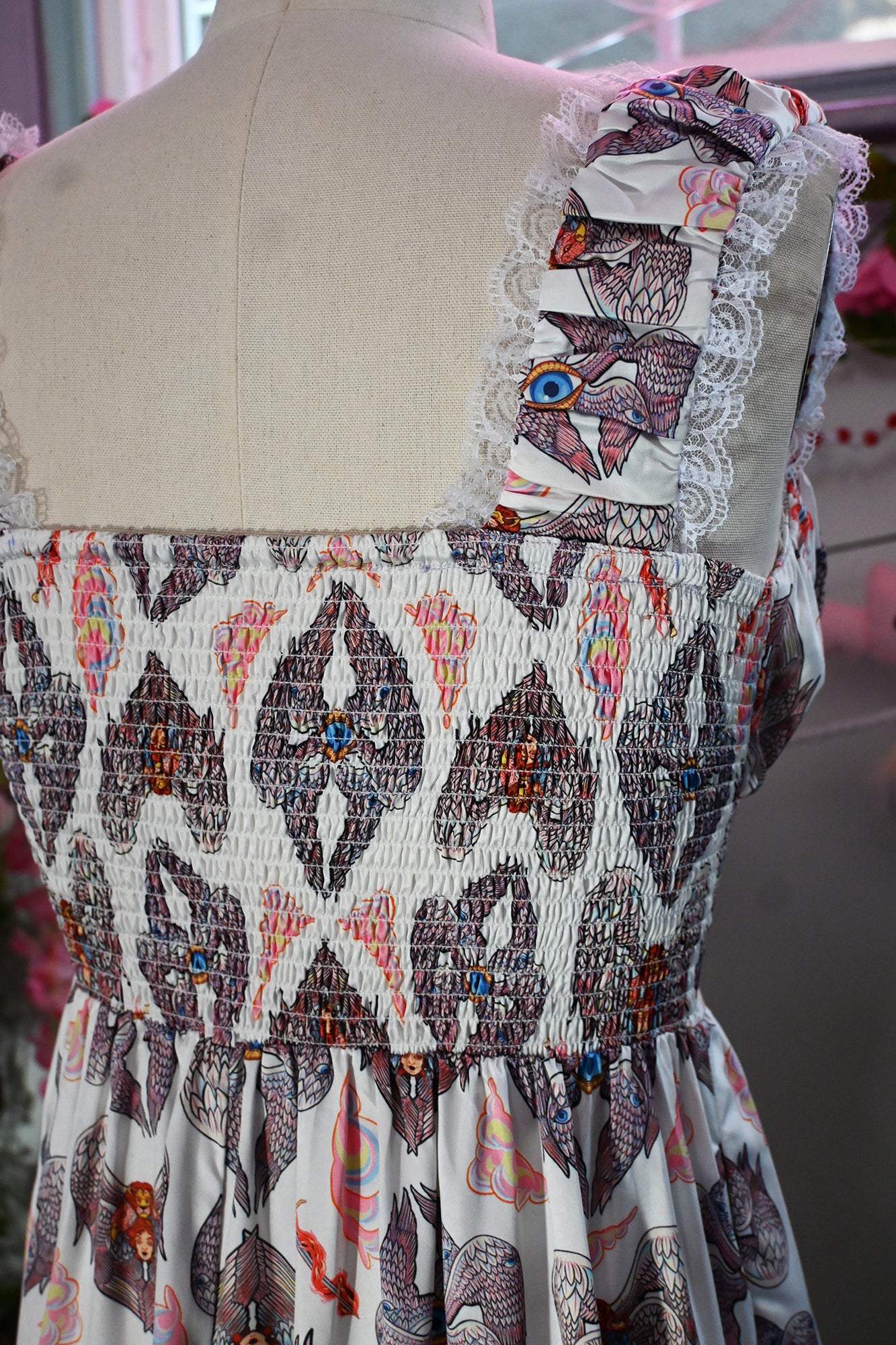 Back view of the Cosette Maxi Dress featuring smocked bodice, lace trim, and vibrant Heavenly Bodies print.
