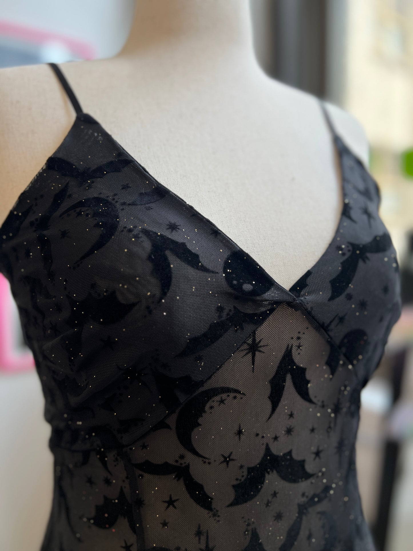 Lily Slip Dress in black mesh with flocked bats, moons, and stars. Features adjustable straps and glitter sparkle.
