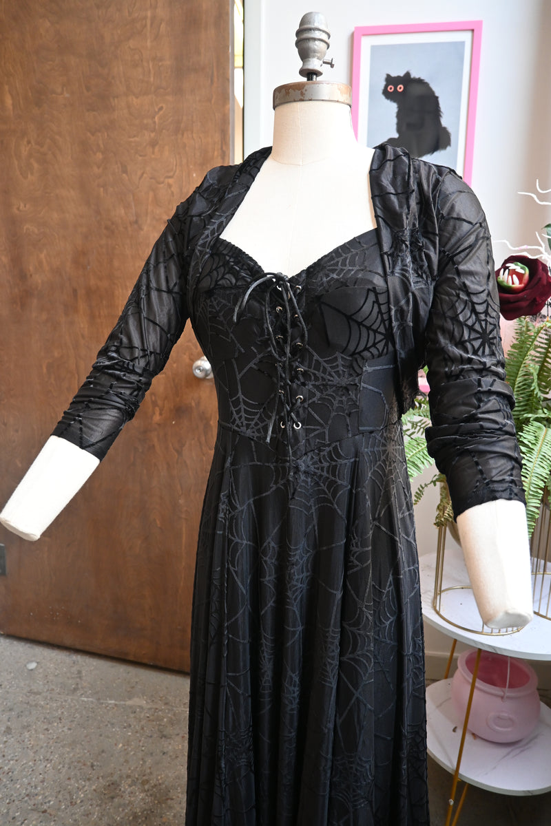 Elegant black willow dress with spiderweb print and matching bolero, featuring velvet straps and lace-up front.