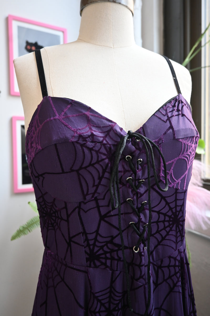 Close-up of Willow Dress featuring violet velvet burnout spiderweb fabric and lace-up front detail.