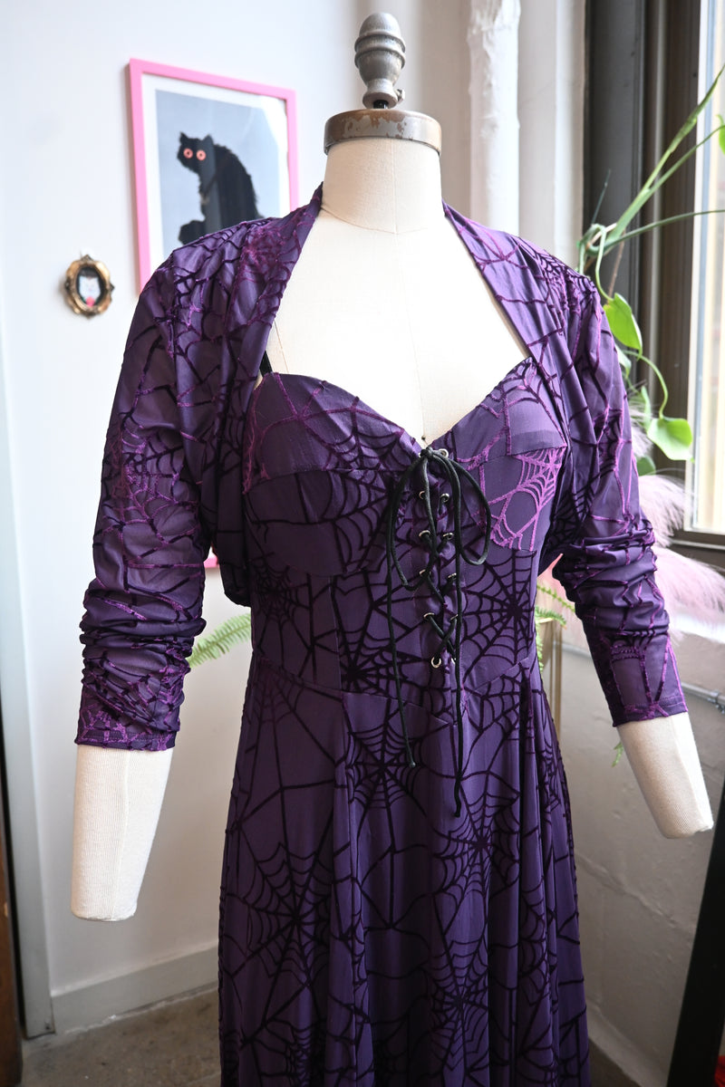 Violet velvet burnout spiderweb dress with matching bolero showcasing lace-up front and shimmering lining.