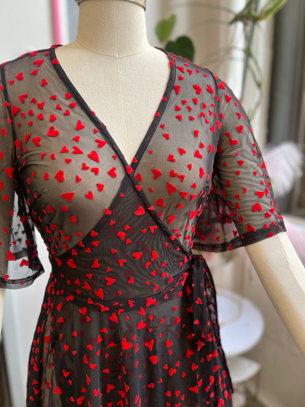 Lydia Wrap Dress in Black Queen of Hearts flocked mesh with red heart details, perfect for Valentine's Day and outings.