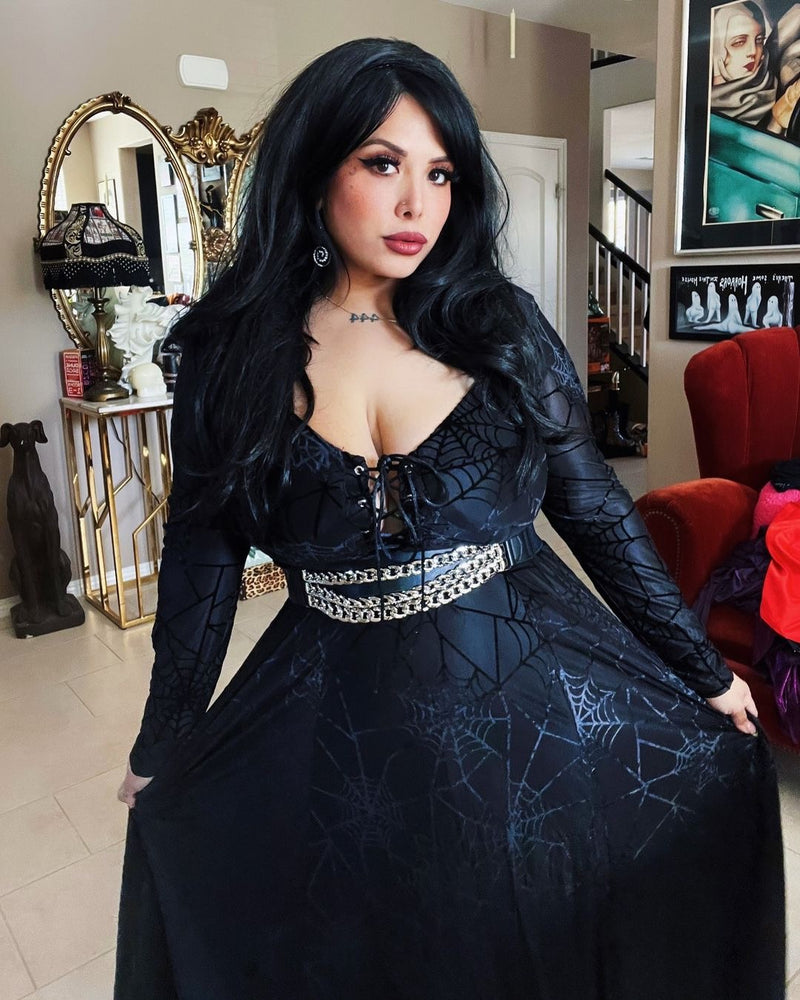 Gothic fashion: model in black spiderweb burnout velvet dress with lace-up front and matching bolero, showcasing shimmer lining.