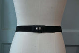 Black elastic belt with faux leather and silver chain detail